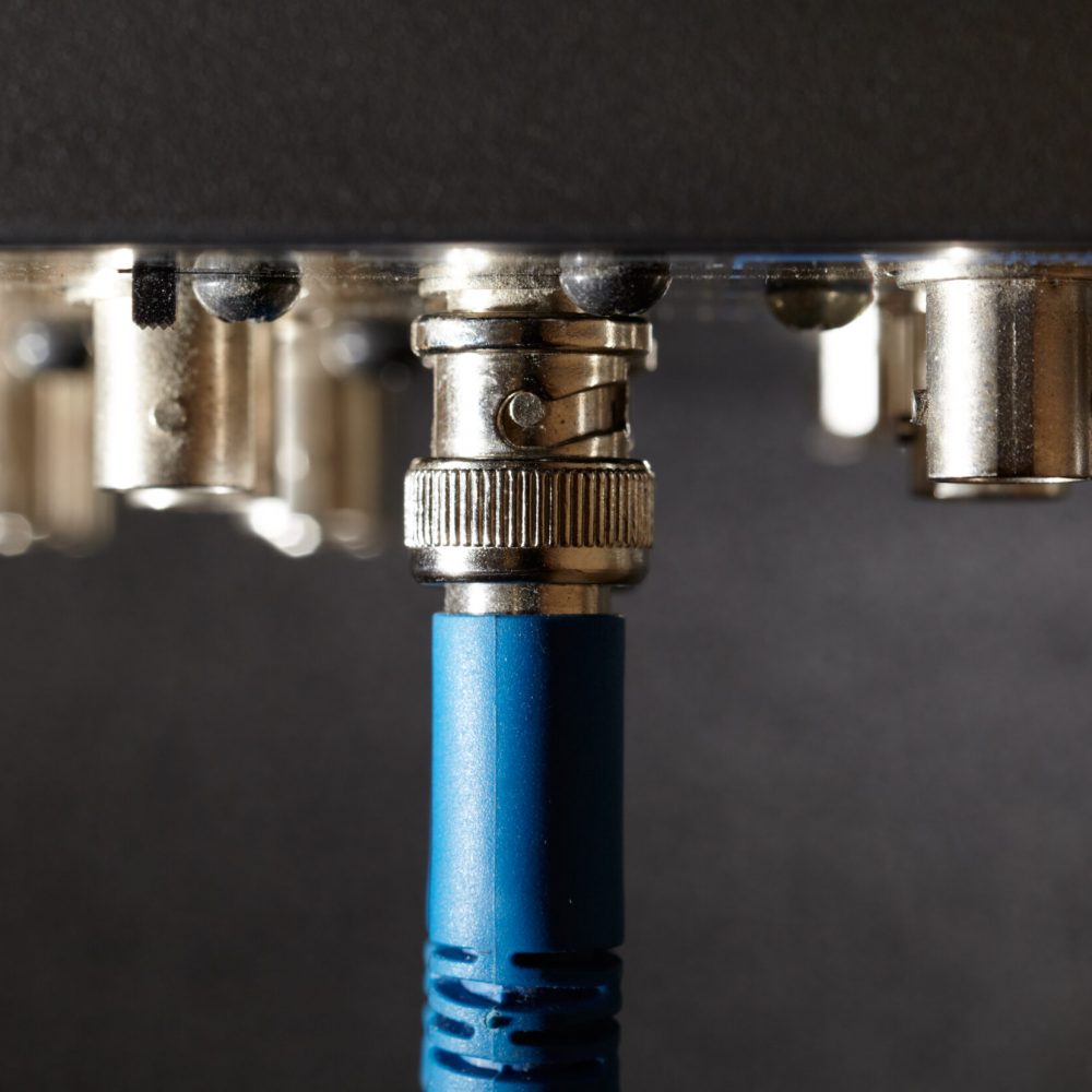 Macro shot of the HD SDI-video cable and digital video connectors on the back of the professional vcr